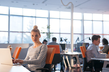 Image showing businesswoman using a laptop in startup office