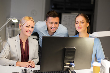 Image showing business team with computer working late at office