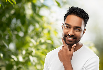 Image showing smiling indian man touching his beard