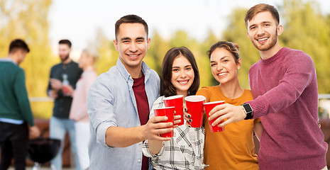 Image showing group of friends toasting drinks at rooftop party