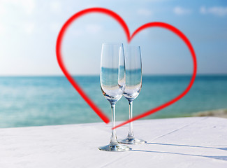 Image showing two champagne glasses framed by red heart shape