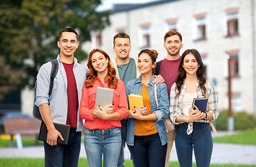 Image showing group of smiling students with books over campus