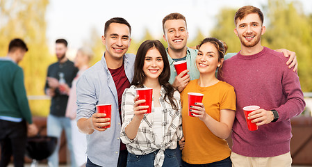 Image showing group of friends toasting drinks at rooftop party