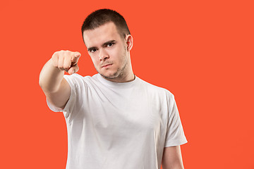 Image showing The overbearing businessman point you and want you, half length closeup portrait on orange background.