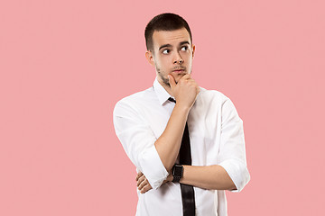 Image showing Young serious thoughtful businessman. Doubt concept.