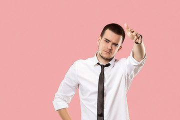 Image showing Beautiful male half-length portrait isolated on pink studio backgroud. The young emotional surprised man