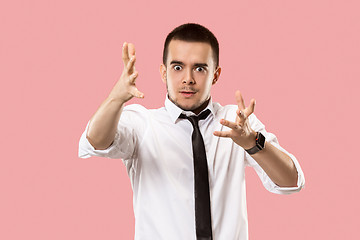 Image showing Beautiful male half-length portrait isolated on pink studio backgroud. The young emotional surprised man