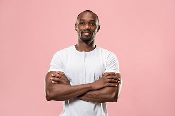 Image showing The happy business man standing and smiling against pink background.