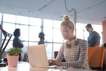 Image showing businesswoman using a laptop in startup office