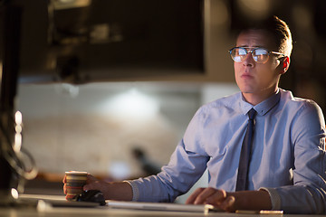 Image showing Tired businessman working late