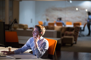 Image showing man using mobile phone in dark office