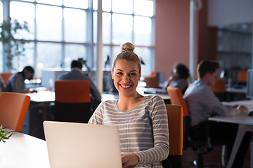 Image showing businesswoman using a laptop in startup office