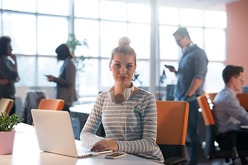 Image showing businesswoman using a laptop in startup office