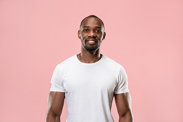 Image showing The happy business man standing and smiling against pink background.