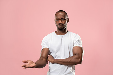 Image showing Beautiful male half-length portrait isolated on pink studio backgroud. The young emotional surprised man