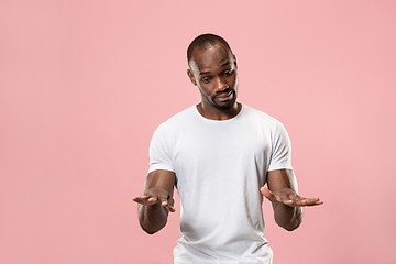 Image showing Beautiful male half-length portrait isolated on pink studio backgroud. The young emotional surprised man