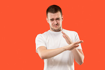 Image showing Let me think. Doubtful pensive man with thoughtful expression making choice against orange background