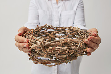 Image showing Girl holding a wreath in her hands