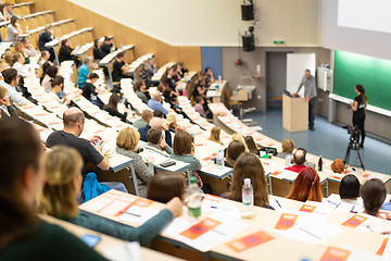 Image showing Expert speaker giving a talk at scientific business conference event.