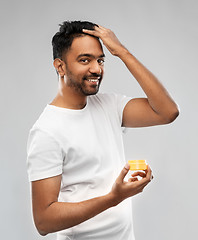 Image showing indian man applying hair wax or styling gel