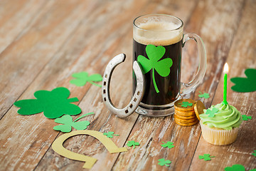 Image showing glass of beer, horseshoe, green cupcake and coins