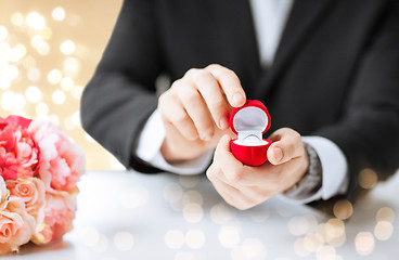 Image showing man with diamond engagement ring in red gift box