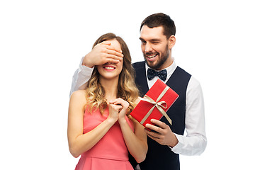 Image showing happy man giving woman surprise present