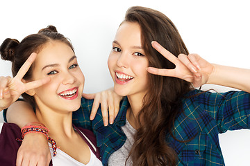 Image showing happy teenage girls hugging and showing peace sign