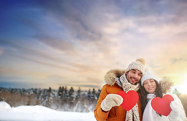 Image showing happy couple with red hearts over winter nature