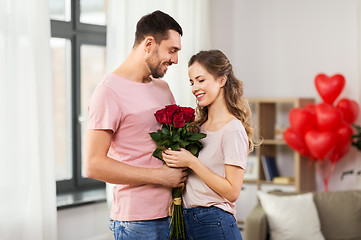 Image showing couple with flowers at home on valentines day