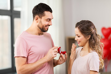 Image showing man giving woman engagement ring on valentines day