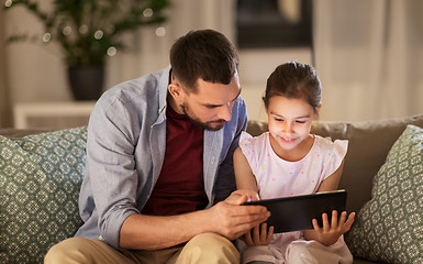 Image showing father and daughter with tablet computer at home