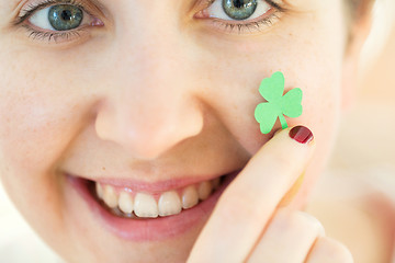 Image showing close up of happy young woman face with shamrock