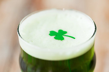 Image showing close up of glass of green beer with shamrock