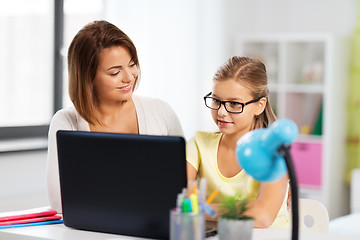 Image showing mother and daughter with laptop doing homework