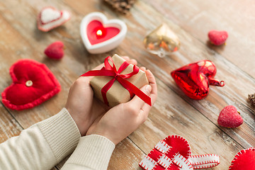 Image showing close up of hands holding christmas gift