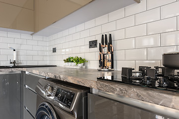 Image showing Closeup of luxury modern white, beige and grey kitchen interior