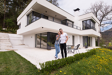 Image showing couple hugging in front of  new luxury home