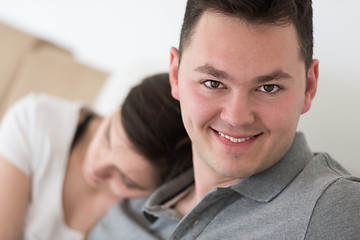 Image showing young couple hugging on the sofa