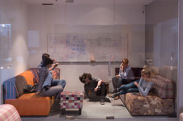 Image showing software developers sleeping on sofa in creative startup office