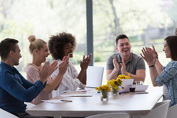 Image showing multiethnic startup Group of young business people celebrating s