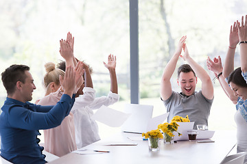 Image showing multiethnic startup Group of young business people throwing docu