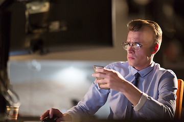 Image showing man using mobile phone in dark office