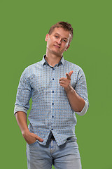 Image showing The overbearing businessman point you and want you, half length closeup portrait on green background.