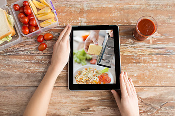 Image showing woman watching cooking video on tablet computer