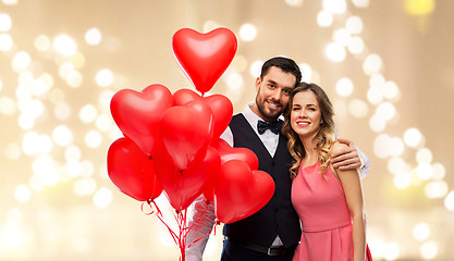 Image showing happy couple with red heart shaped balloons