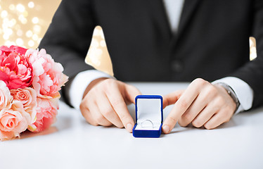 Image showing man with diamond engagement ring in blue gift box