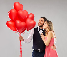 Image showing happy couple with red heart shaped balloons