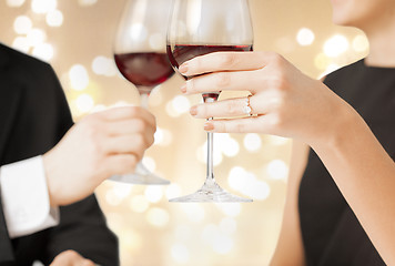 Image showing close up of couple clinking champagne glasses