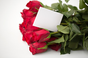 Image showing close up of red roses and letter or note